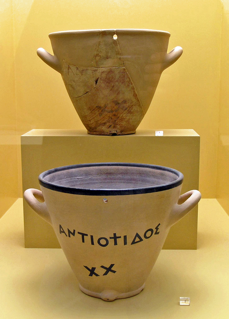 A reconstruction of an ancient Greek Clepsydra, or water clock, made of terracotta and used for measuring time by the regulated flow of liquid.
